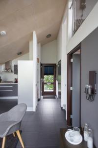 a hallway of a kitchen with a table and chairs at Vakantiehuis Olivia in Schoorl