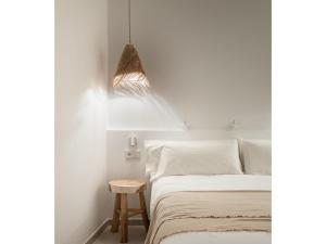 A bed or beds in a room at S'Enclova Petit Hotel