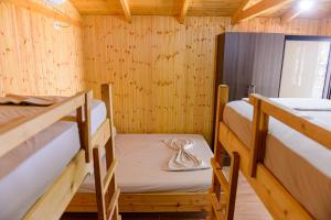 
a bedroom with a bunk bed and a desk at ECUADOR Resort in Zverneci
