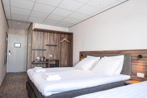 Postel nebo postele na pokoji v ubytování Harbour Hotel IJmuiden