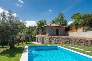a villa with a swimming pool and a house at Casa Velha de Ponta Sôto in Cela