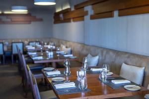 a row of tables in a restaurant with plates and glasses at Monte Santo Resort in Carvoeiro