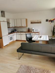 a living room with a couch and a table and a kitchen at Haus Matthias in Umhausen