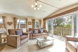 a living room with two couches and a balcony at Host & Stay - Yolo Lodge in Felton
