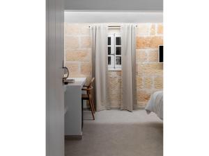 A bed or beds in a room at S'Enclova Petit Hotel