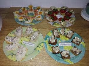 four plates of different types of food on a table at Hotel Sundblick in Altefähr