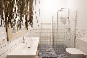 a bathroom with a sink and a shower at Amber-Blue Palanga in Palanga +28 photos