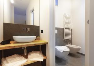 uma casa de banho com um lavatório e um WC em Bed and Breakfast La Coa em Auronzo di Cadore