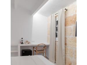 A kitchen or kitchenette at S'Enclova Petit Hotel