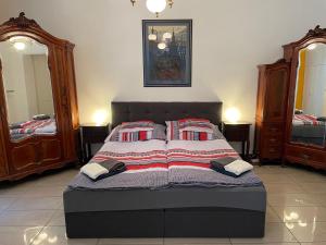 a bedroom with a bed with pillows on it at Buda Castle Apartment in Budapest