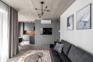 a living room with a couch and a table at Urban center apartment in Vilnius