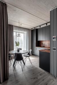 a kitchen and dining room with a table and chairs at Urban center apartment in Vilnius