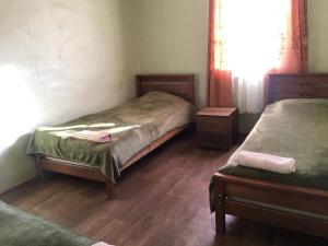 mały pokój z 2 łóżkami i oknem w obiekcie Guesthouse Omalo w mieście Omalo