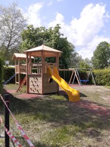 a playground with a slide and a gazebo at Hoamat#am#See in Seekirchen am Wallersee