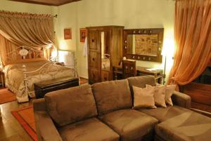 a living room with a couch and a bed at Luxury Guesthouse Pantheon in Palaios Panteleimon