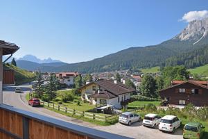 a view of a town with cars parked in a parking lot at Design Residence Del Passo in Padola