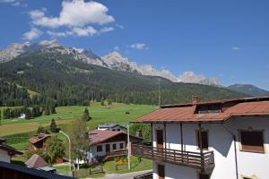 a view of a village with mountains in the background at Design Residence Del Passo in Padola