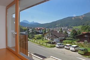 a room with a window with a view of a street at Design Residence Del Passo in Padola