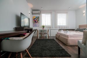 a living room with a bed and a desk at 5 STAR CENTRAL STUDIO in Skopje
