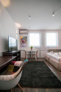 a bedroom with a bed and a couch and a table at 5 STAR CENTRAL STUDIO in Skopje
