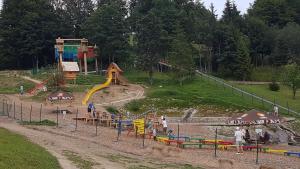 a childrens park with a playground with a slide at Apartmanica Triangel 103 in Donovaly