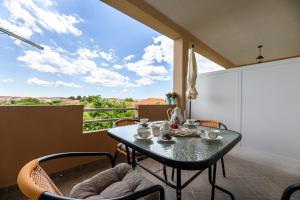 a dining room with a table and chairs on a balcony at Apartments Anita in Bibinje