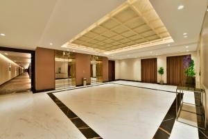 a lobby with a marble floor and a ceiling at Bahrain Airport Hotel Airside Hotel for Transiting and Departing Passengers only in Muharraq
