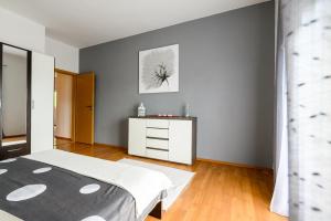a bedroom with a white bed and a white dresser at Apartments Anita in Bibinje
