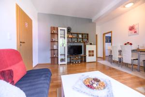 a living room with a couch and a table at Apartments Anita in Bibinje