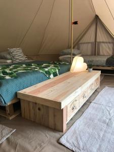 a room with two beds and a table in a tent at Dordogne Glamping in Bouzic