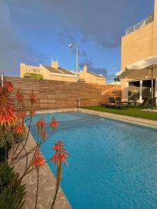 a swimming pool in front of a building at Valdevebas Chalet con Piscina in Madrid