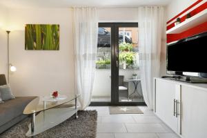 a living room with a couch and a tv at Ferienwohnung Sauermann in Markdorf