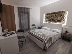 a bedroom with a bed and a table and chairs at La luce di Ambra in Pagliara