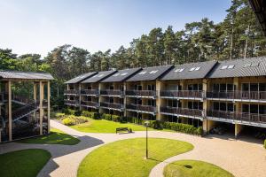 a large building with solar panels on the roof at Natura Resort in Pogorzelica +69 photos