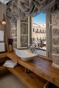 a bathroom with a sink in front of a window at Apartments Hun in Kotor