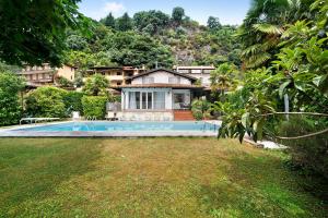 a house with a swimming pool in a yard at Luxury Country House Domaso in Domaso