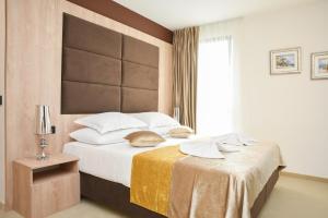 a bedroom with a bed and a large window at Hotel Meduza in Senj