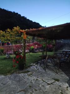 a patio with a table and chairs in a yard at XENONAS SOULIOU in Samonída