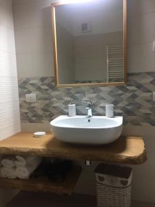 a bathroom with a white sink and a mirror at LE RONDINI HOUSE in Monopoli