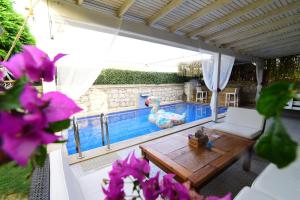 a pool with a table and a rubber duck toy at My Adress Alaçatı Butik Otel in Alacati