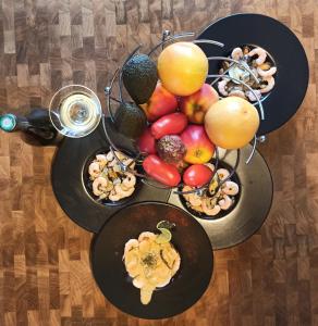a table topped with plates of fruits and vegetables at Chambre d'hote Le clos Valmont in Fécamp +9 photos