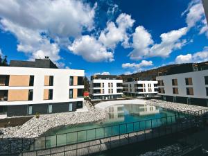 a view of the courtyard of a building with a pool at VISLOW Resort in Wisła