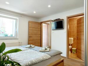 a bedroom with a bed with two towels on it at Apartments Sušnik in Bohinj