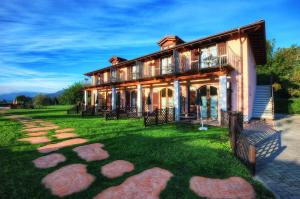 a large house with a green lawn in front of it at Agriturismo alla Poncia in Gravedona