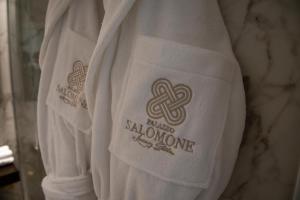 a white shirt with a logo on the back of it at Palazzo Salomone in Siracusa