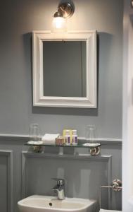 a bathroom with a sink and a mirror at Old Post Office in Slane