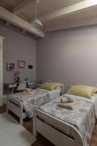 a room with two beds and a table with a desk at La Vecchia Dimora in Marrùbiu