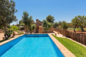 a swimming pool in the backyard of a house at Villa Es Tres Pins in Campos