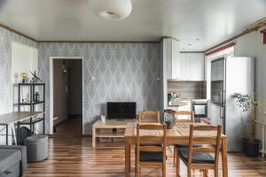 a kitchen and dining room with a table and chairs at Haapsalu Sky Seat in Haapsalu
