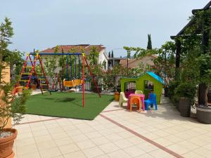 a playground with a slide and a swing set at Apartments Villa Viktoria in Tivat